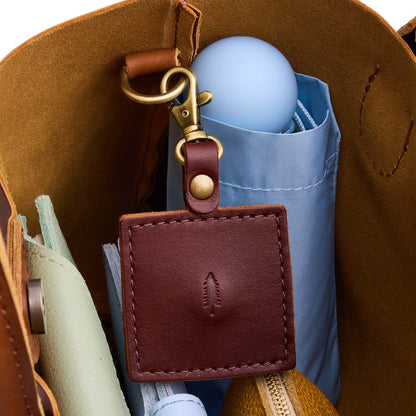 Cognac | Square-shaped leather AirTag holder with snap closure and swivel lobster claw clasp