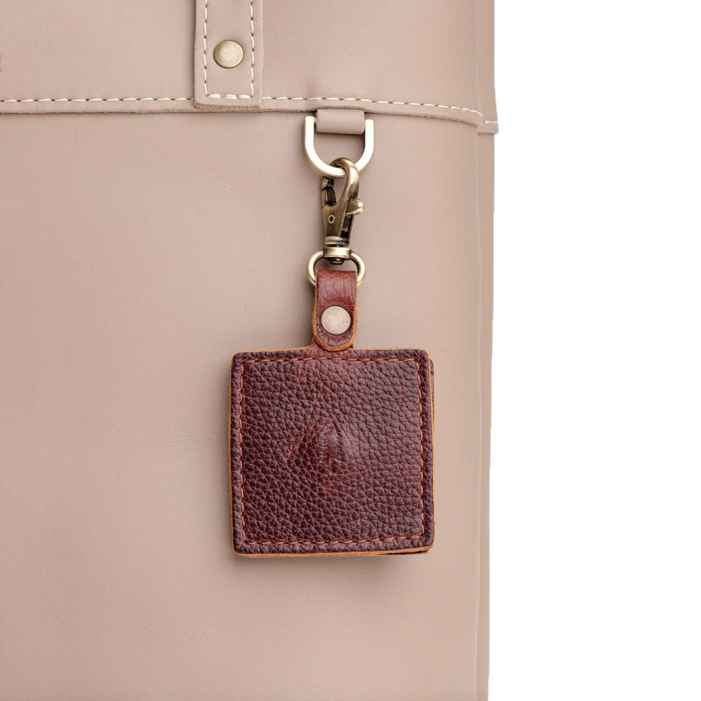 Nutmeg | Square-shaped leather AirTag holder with snap closure and swivel lobster claw clasp