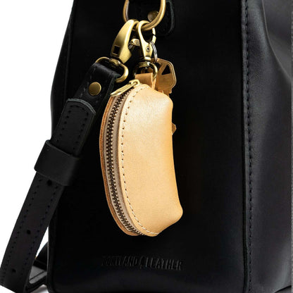 Champagne | Taco shaped leather pouch with zipper and swivel lobster clasp on bag