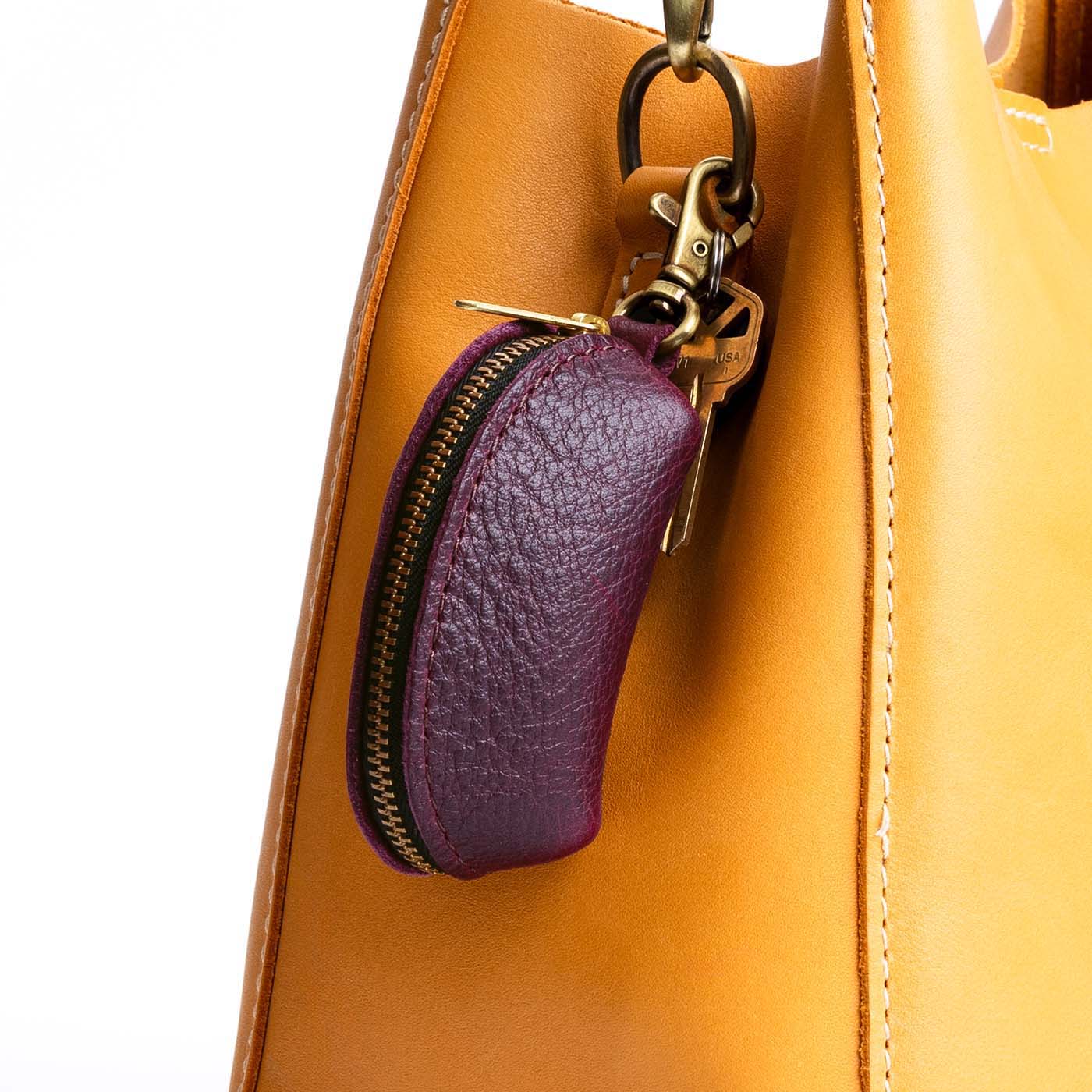 Plum | Taco shaped leather pouch with zipper and swivel lobster clasp on bag