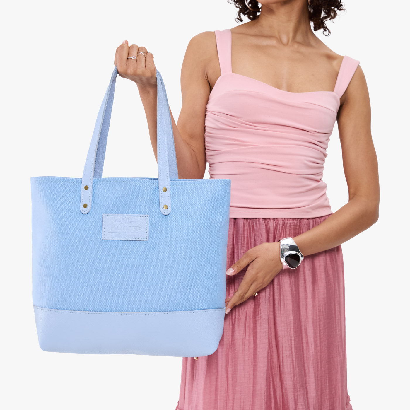 Icy | Model holding canvas tote with leather base and handles