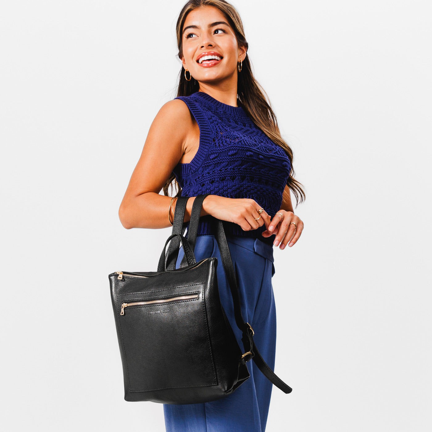 All Color: Pebbled--black*Large | Model holding square slim leather tote backpack