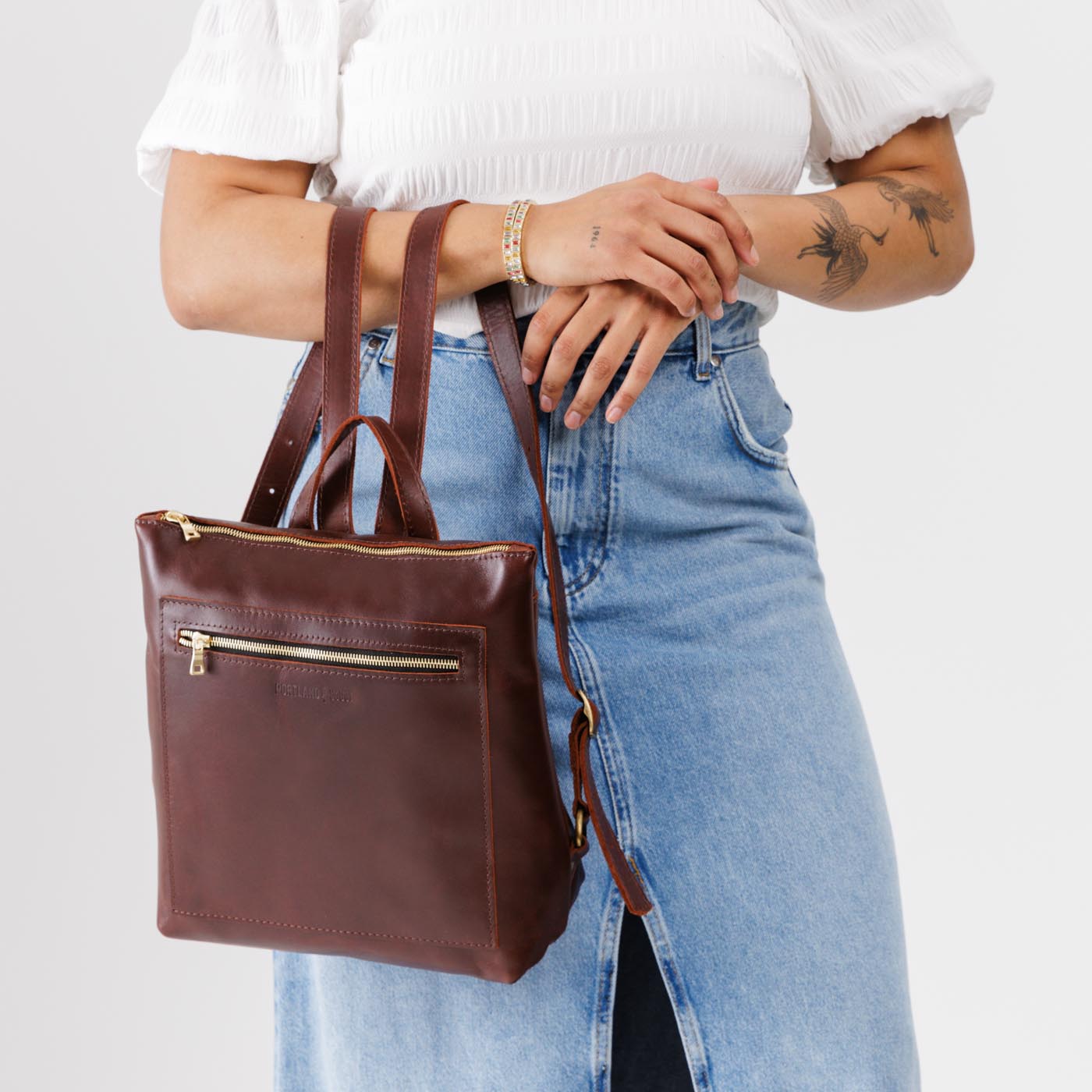 All Color: Cognac*Large | Model holding square slim leather tote backpack