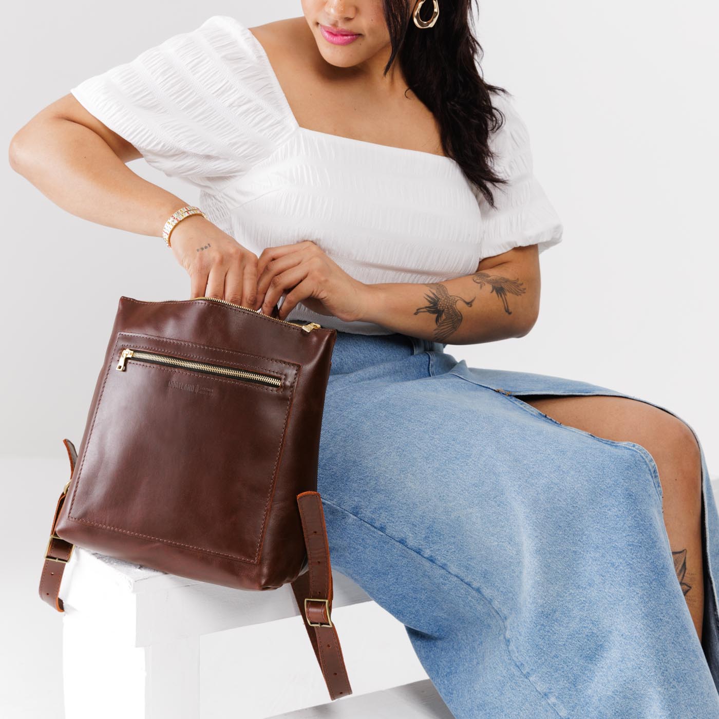 All Color: Cognac*Large | Model holding square slim leather tote backpack