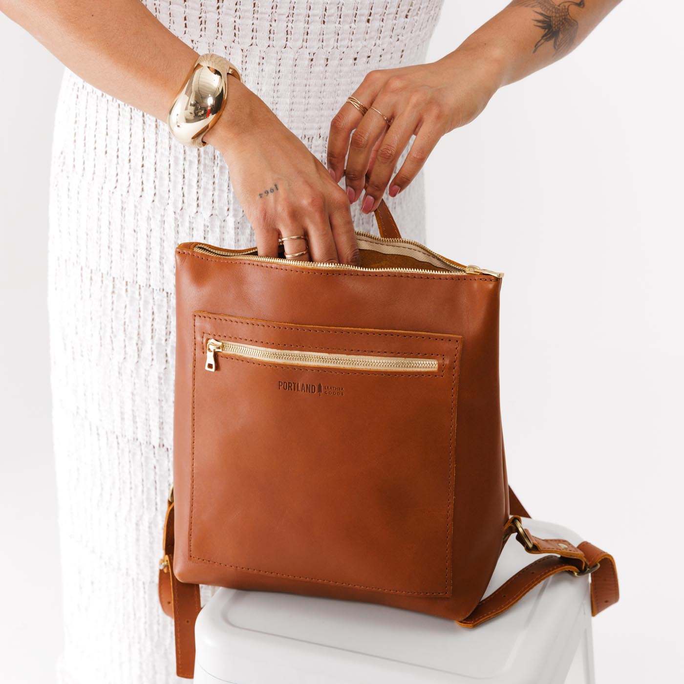 All Color: Honey*Large | Model holding square slim leather tote backpack