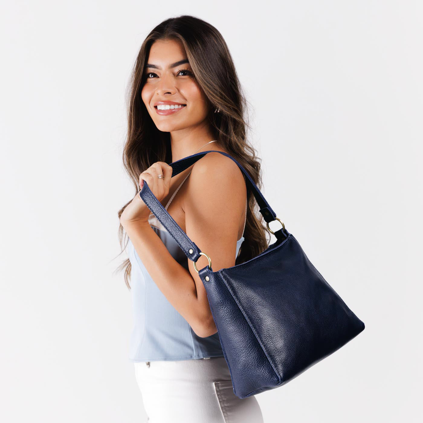 Cobalt*Small | Model carrying triangular shoulder bag with antiqued brass finished hardware