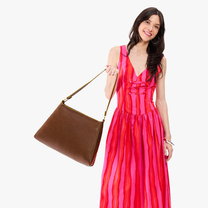 Asheville*Large | Model carrying large triangular shoulder bag with antiqued brass finished hardware