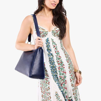 Cobalt*Large | Model carrying large triangular shoulder bag with antiqued brass finished hardware