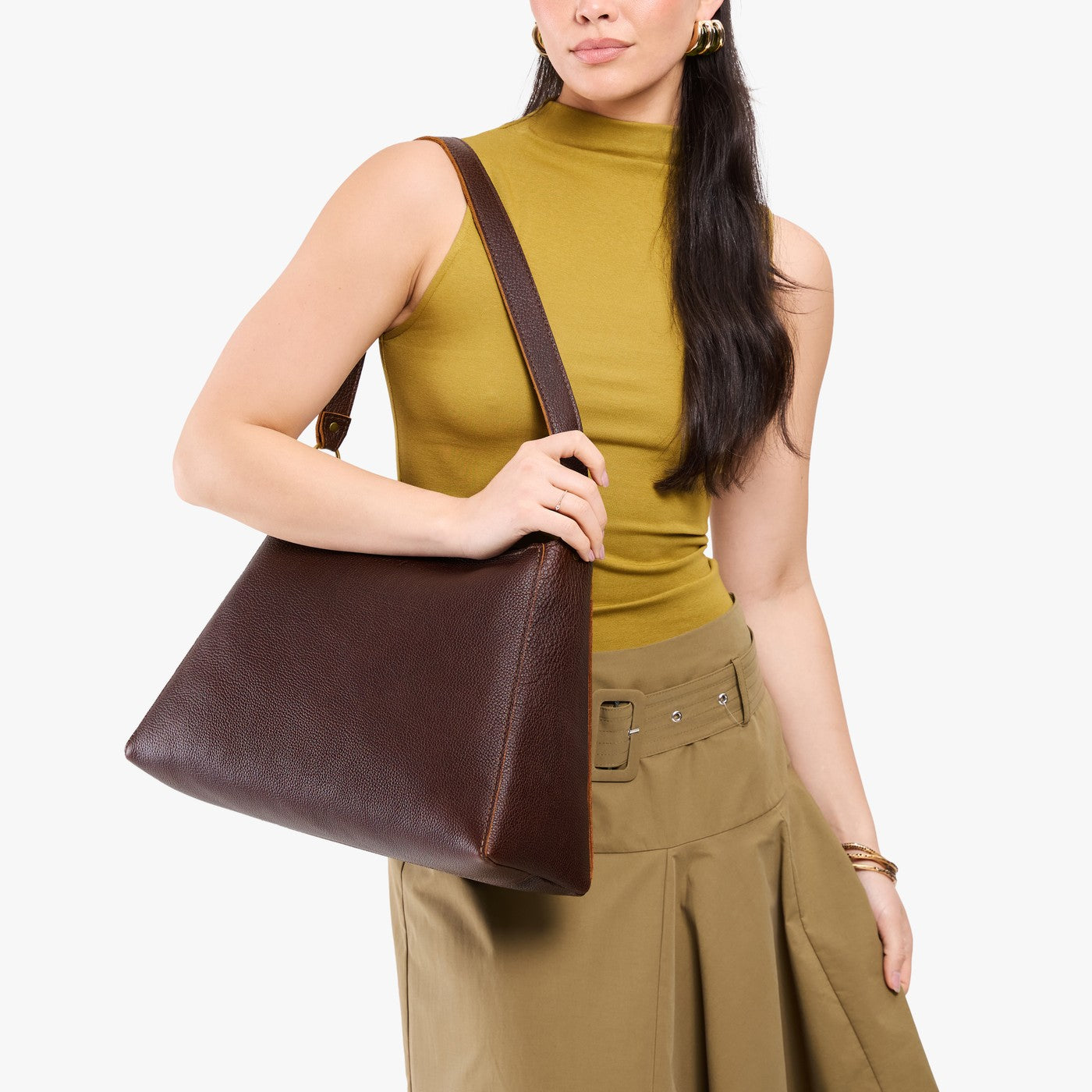 Coldbrew*Large | Model carrying large triangular shoulder bag with antiqued brass finished hardware