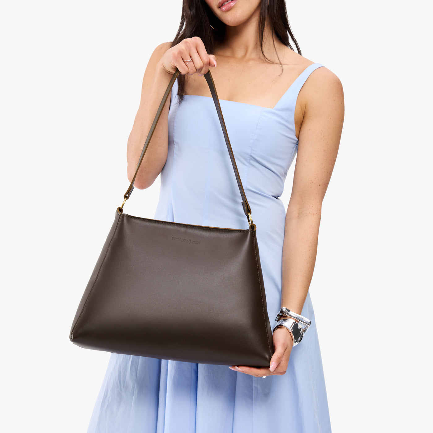 Grizzly*Large | Model holding large triangular shoulder bag with antiqued brass finished hardware
