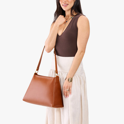 Honey*Large | Model carrying large triangular shoulder bag with antiqued brass finished hardware