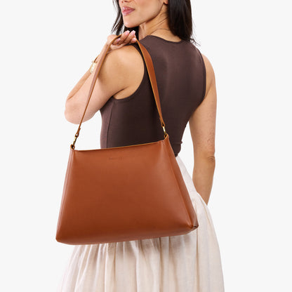 Honey*Large | Model carrying large triangular shoulder bag with antiqued brass finished hardware