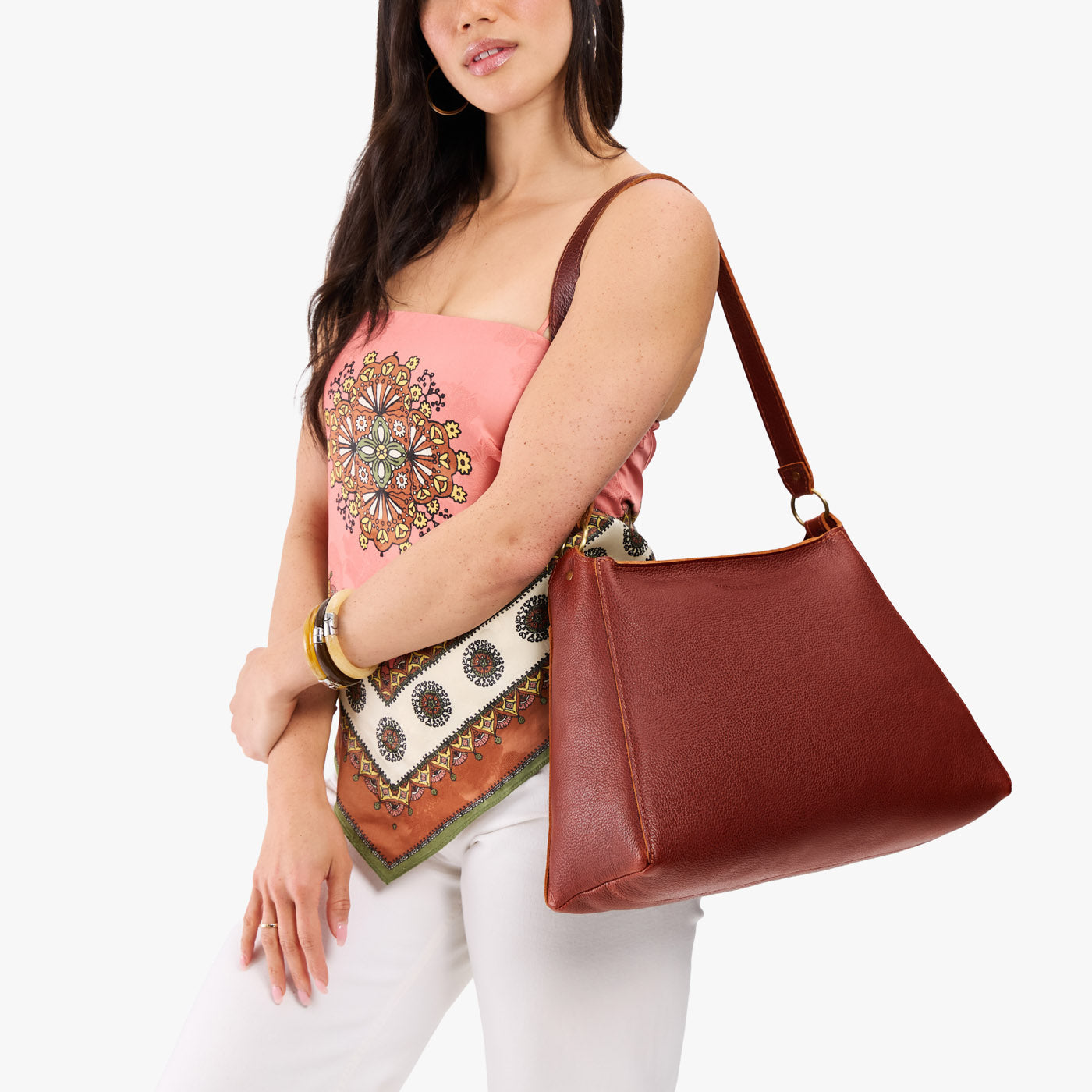 Nutmeg*Large | Model carrying large triangular shoulder bag with antiqued brass finished hardware