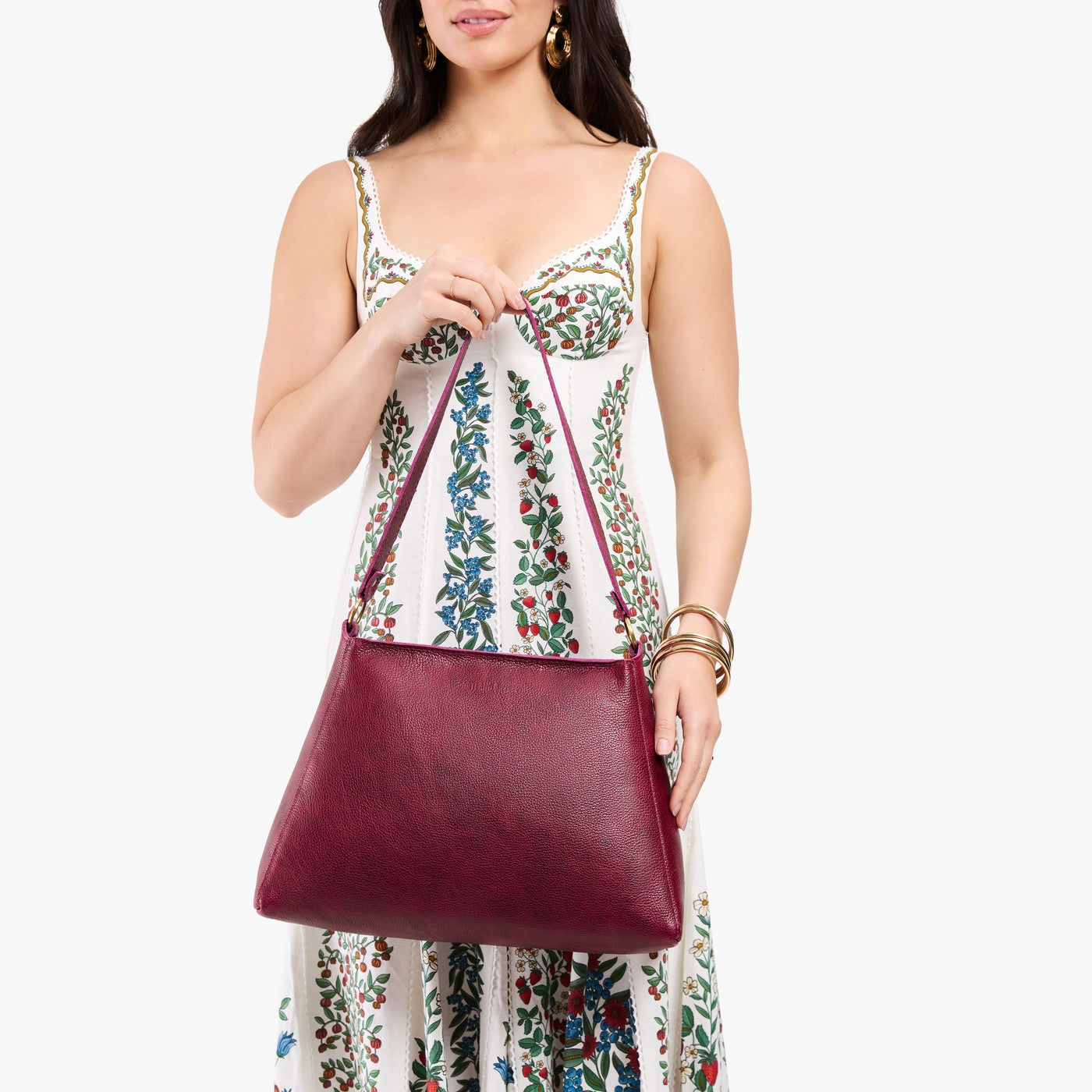 Orchid*Large | Model holding large triangular shoulder bag with antiqued brass finished hardware