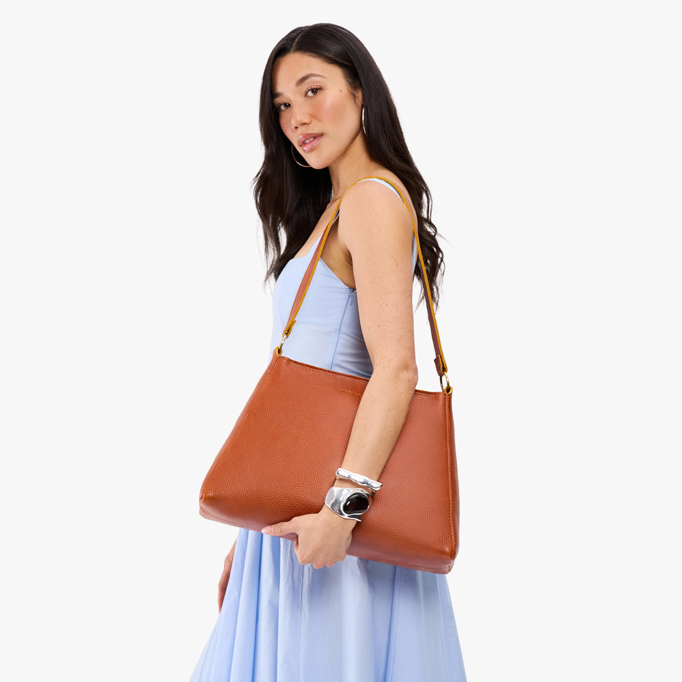 Sienna*Large | Model carrying large triangular shoulder bag with antiqued brass finished hardware