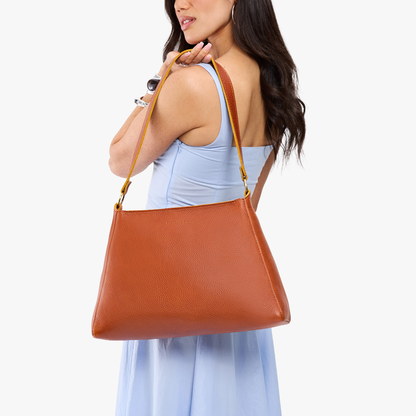 Sienna*Large | Model carrying large triangular shoulder bag with antiqued brass finished hardware