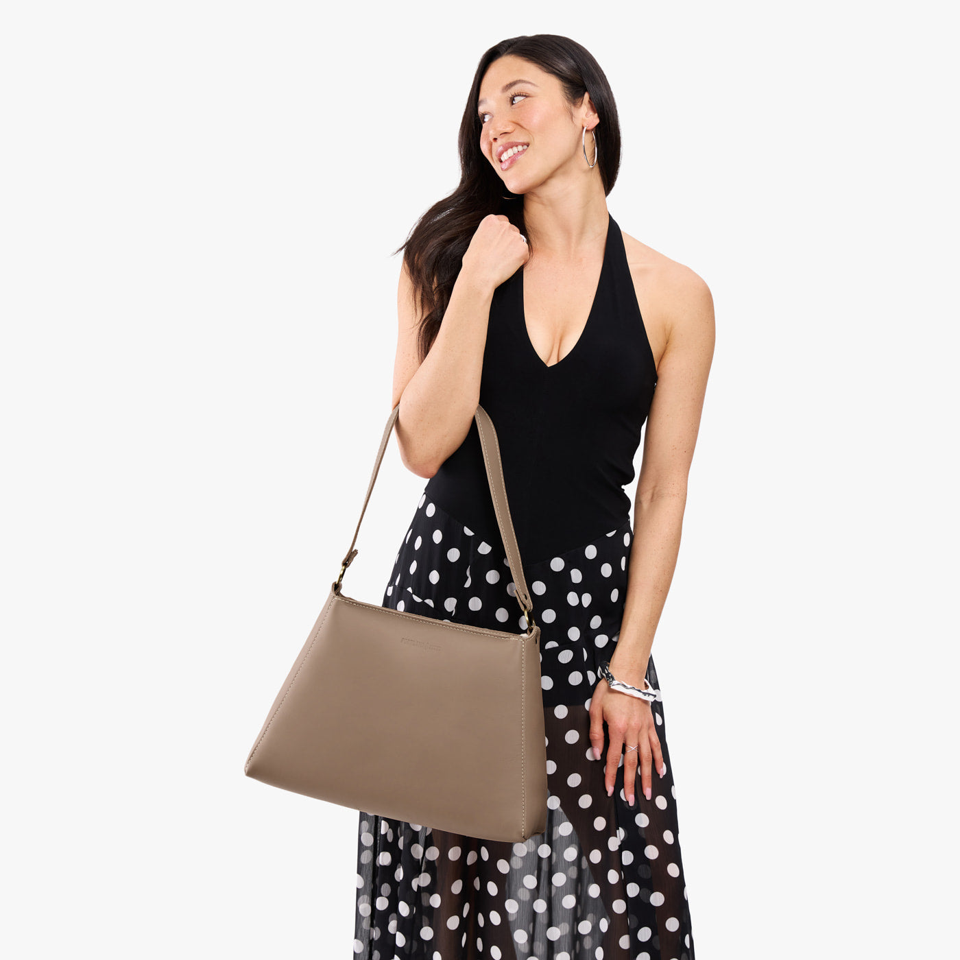 Stone*Large | Model carrying large triangular shoulder bag with antiqued brass finished hardware
