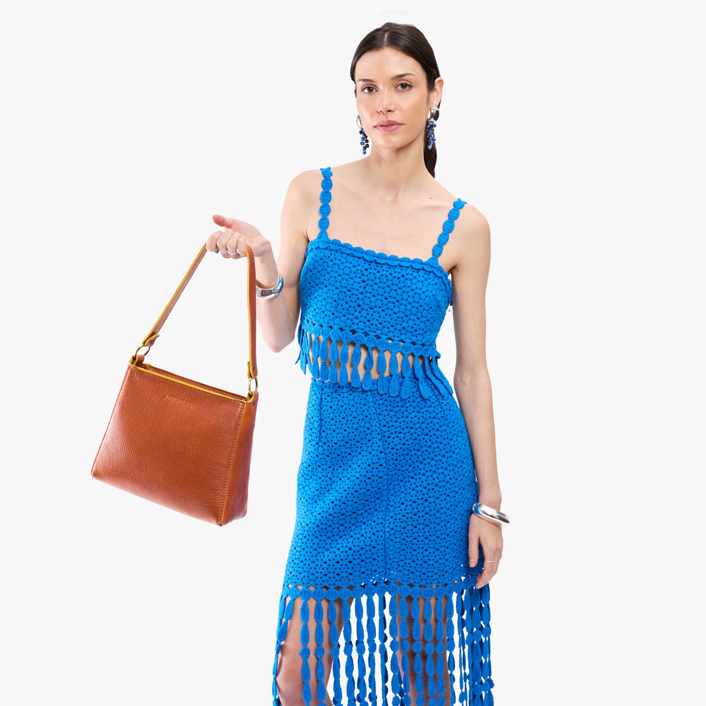 Sienna*Small | Model holding triangular shoulder bag with antiqued brass finished hardware