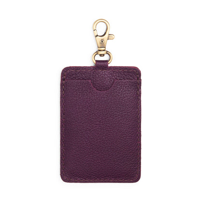 Plum | A leather card holder with a swivel lobster clasp on a white background