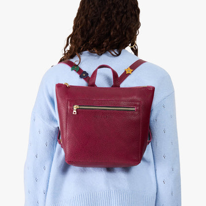 Orchid | Model wearing a petite square slim leather tote backpack with zipper closure and adjustable straps