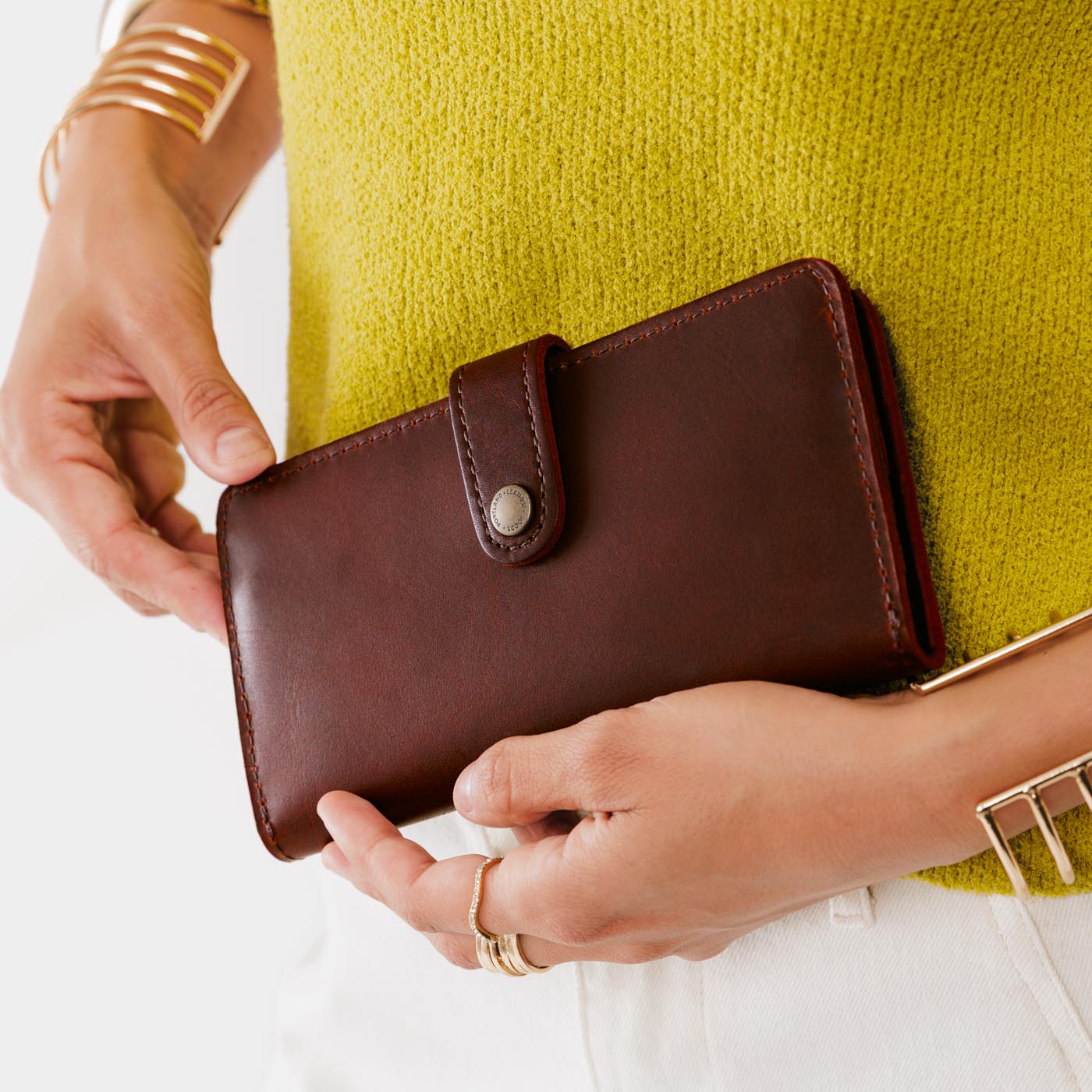 Cognac | Model holding leather wallet with snap closed