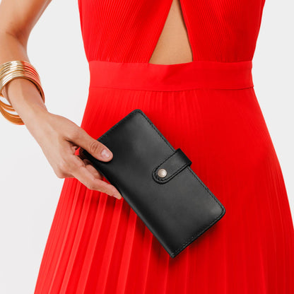 Black | Model holding leather wallet with snap closed