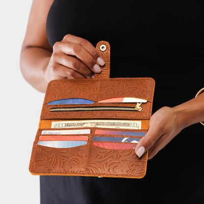 Meadow | Model holding leather wallet with snap open