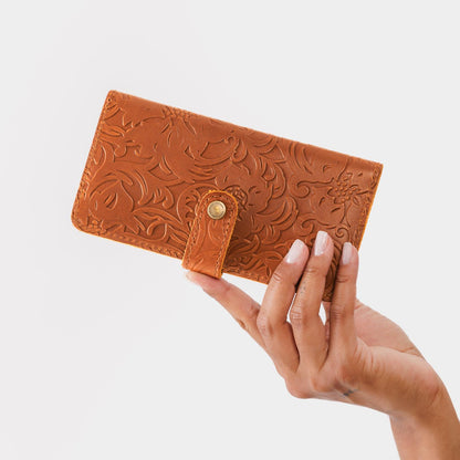 Meadow | Model holding leather wallet with snap closed