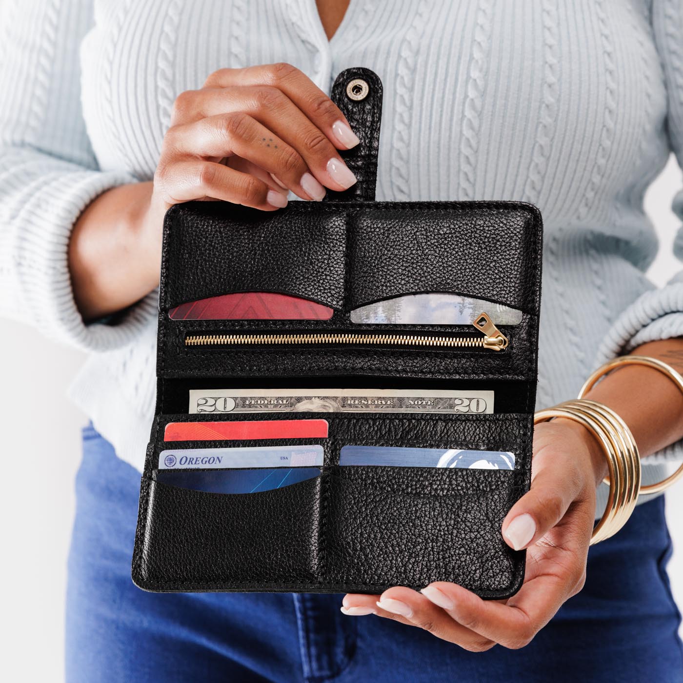 Pebbled--black | Model holding leather wallet with snap open