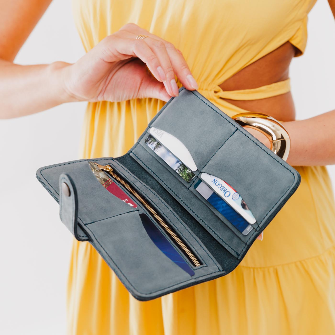 Storm | Model holding leather wallet with snap open